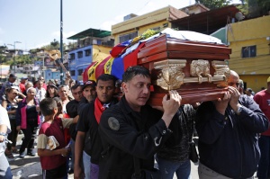 Relatives carry the coffin of Juan "Juancho" Montoya during his funeral in Caracas